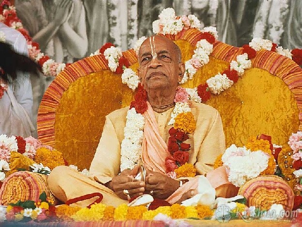 His Divine Grace A.C. Bhaktivedanta Swami Prabhupada, seated on a flower-decorated vyasasana